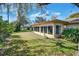 Spacious sunroom with multiple windows providing plenty of natural light and views of the landscaped backyard at 8420 Winding Wood Dr, Port Richey, FL 34668