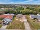 An aerial view showcases the residential neighborhood and single-story home with well-maintained lawns at 8528 Viva Via Dr, Hudson, FL 34667