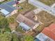 Aerial view of the home showing backyard, sunroom, and surrounding greenery at 8528 Viva Via Dr, Hudson, FL 34667