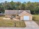 Charming single-story home with a well-manicured lawn and stone facade, complemented by a one-car garage at 8528 Viva Via Dr, Hudson, FL 34667