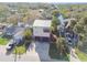 Aerial view of a home with a metal roof, spacious driveway, and mature palm trees at 8721 Old Post Rd, Port Richey, FL 34668
