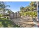 Large, well-maintained backyard with a fire pit, mature landscaping, and plenty of space for activities at 8721 Old Post Rd, Port Richey, FL 34668
