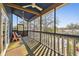 Enjoy the outdoors on this covered balcony with water views, a ceiling fan, and comfortable seating at 8721 Old Post Rd, Port Richey, FL 34668