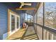 Relax on this covered balcony with a ceiling fan and comfortable seating, perfect for enjoying the outdoors at 8721 Old Post Rd, Port Richey, FL 34668