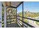 Enjoy the view from this screened balcony with wood floors and railings overlooking a tree lined street at 8721 Old Post Rd, Port Richey, FL 34668