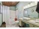 Stylish bathroom featuring a modern vanity, shower with white tile, and wood-paneled ceiling at 8721 Old Post Rd, Port Richey, FL 34668