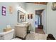 Charming bathroom with a vessel sink, wood paneled ceiling, and access to the primary bedroom at 8721 Old Post Rd, Port Richey, FL 34668
