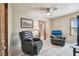 Cozy bedroom featuring comfortable chairs, a ceiling fan, and plenty of natural light at 8721 Old Post Rd, Port Richey, FL 34668