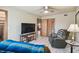 Comfortable bedroom with ceiling fan, television, and easy access to additional rooms at 8721 Old Post Rd, Port Richey, FL 34668