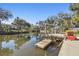 Waterfront property featuring a private dock with a boat lift and serene water views at 8721 Old Post Rd, Port Richey, FL 34668