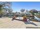 Private dock with a boat lift and planters, providing direct access to the water at 8721 Old Post Rd, Port Richey, FL 34668