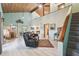 Bright living room boasts high ceilings with exposed wood beams and an open floor plan to the kitchen at 8721 Old Post Rd, Port Richey, FL 34668