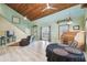 Spacious living room with high, exposed-beam ceilings, light wood floors, and an open layout at 8721 Old Post Rd, Port Richey, FL 34668