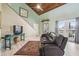 Bright living room with vaulted ceilings, access to balcony, and stylish wood-look flooring at 8721 Old Post Rd, Port Richey, FL 34668