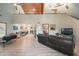 Open-concept living room featuring vaulted wood ceilings, and a view to the kitchen and dining area at 8721 Old Post Rd, Port Richey, FL 34668