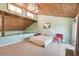 Bright main bedroom with a wood ceiling, plush carpet, and upper level gallery at 8721 Old Post Rd, Port Richey, FL 34668