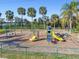 A vibrant playground with slides, swings, and benches for relaxation amid lush, green surroundings at 8721 Old Post Rd, Port Richey, FL 34668