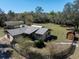 Aerial view of property with a fenced yard, shed, car port, and a view of the surrounding landscape at 9382 Wild Horse Trl, Brooksville, FL 34601