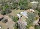 Aerial view of the property, showcasing the home, outbuildings, and surrounding landscape at 9382 Wild Horse Trl, Brooksville, FL 34601