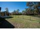 Spacious backyard with a screened-in porch, barn, and ample green space for recreation at 9382 Wild Horse Trl, Brooksville, FL 34601