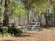 Rustic backyard gate with mature trees, providing a charming entrance to a serene and private outdoor space at 9382 Wild Horse Trl, Brooksville, FL 34601