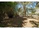 Picturesque backyard featuring mature trees and partial fencing, perfect for creating a serene and private outdoor space at 9382 Wild Horse Trl, Brooksville, FL 34601