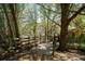 Charming backyard with mature trees, partial fencing, and a unique entrance, ideal for creating a private oasis at 9382 Wild Horse Trl, Brooksville, FL 34601
