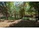 Beautiful backyard with mature trees and partial fencing, ideal for creating a tranquil and private retreat at 9382 Wild Horse Trl, Brooksville, FL 34601