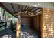 Rustic barn interior with wooden beams, stalls, and ample space for storage or livestock at 9382 Wild Horse Trl, Brooksville, FL 34601