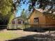 Exterior shot of the barn on the property with its wooden siding, positioned behind a wooden fence at 9382 Wild Horse Trl, Brooksville, FL 34601