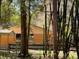 View of the wooden barn, complemented by thriving cacti and natural trees on the expansive land at 9382 Wild Horse Trl, Brooksville, FL 34601