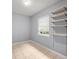 Neutral bedroom with tiled floor, closet, large window, and shelving to the right at 9382 Wild Horse Trl, Brooksville, FL 34601