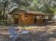 Exterior view of a building with a chair and small table in front of it at 9382 Wild Horse Trl, Brooksville, FL 34601