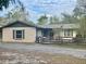 Charming single-story home featuring a neutral paint scheme, classic windows and a wood fence at 9382 Wild Horse Trl, Brooksville, FL 34601