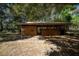 Exterior view of wooden barn surrounded by lots of trees at 9382 Wild Horse Trl, Brooksville, FL 34601