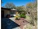 Landscaped front yard with stone pathway and decorative plants leading to the entrance of the home at 9382 Wild Horse Trl, Brooksville, FL 34601