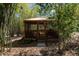 Wooden backyard gazebo with a screened enclosure, surrounded by a tranquil bamboo grove at 9382 Wild Horse Trl, Brooksville, FL 34601
