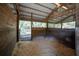 View of the interior of a horse stall featuring wood paneling and wood chip flooring at 9382 Wild Horse Trl, Brooksville, FL 34601