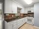 Well-lit kitchen featuring white cabinets, stainless steel appliances, and tiled backsplash at 9382 Wild Horse Trl, Brooksville, FL 34601