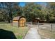 Shed with fencing, landscaping, and a charming pathway at 9382 Wild Horse Trl, Brooksville, FL 34601