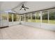 Spacious sunroom with tile flooring, many windows offering natural light, and a fan at 9382 Wild Horse Trl, Brooksville, FL 34601