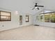 Sunroom featuring tile flooring, multiple doors, several windows and an overhead fan at 9382 Wild Horse Trl, Brooksville, FL 34601