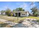 Inviting single-story home with a paved driveway and minimalist landscaping at 9430 Chase St, Spring Hill, FL 34608