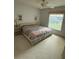 Well-lit bedroom featuring neutral carpet and a large window at 11121 Linkside Dr # 11121, Port Richey, FL 34668