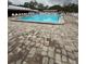 Large community swimming pool surrounded by pavers and lounge chairs, perfect for relaxation at 11121 Linkside Dr # 11121, Port Richey, FL 34668