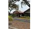 Inviting entrance to Timber Oaks, featuring a covered walkway and manicured landscaping at 11121 Linkside Dr # 11121, Port Richey, FL 34668