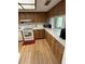 Kitchen featuring wood cabinets, white countertops, appliances, and hardwood flooring at 11121 Linkside Dr # 11121, Port Richey, FL 34668