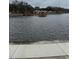 Scenic water view featuring a charming pier and waterfront homes in a tranquil community at 11121 Linkside Dr # 11121, Port Richey, FL 34668