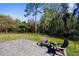 Outdoor seating on the back patio overlooking the yard with wooded views at 11227 Lakeview Dr, New Port Richey, FL 34654