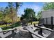 Outdoor fire pit with Adirondack chairs in fenced yard at 11227 Lakeview Dr, New Port Richey, FL 34654